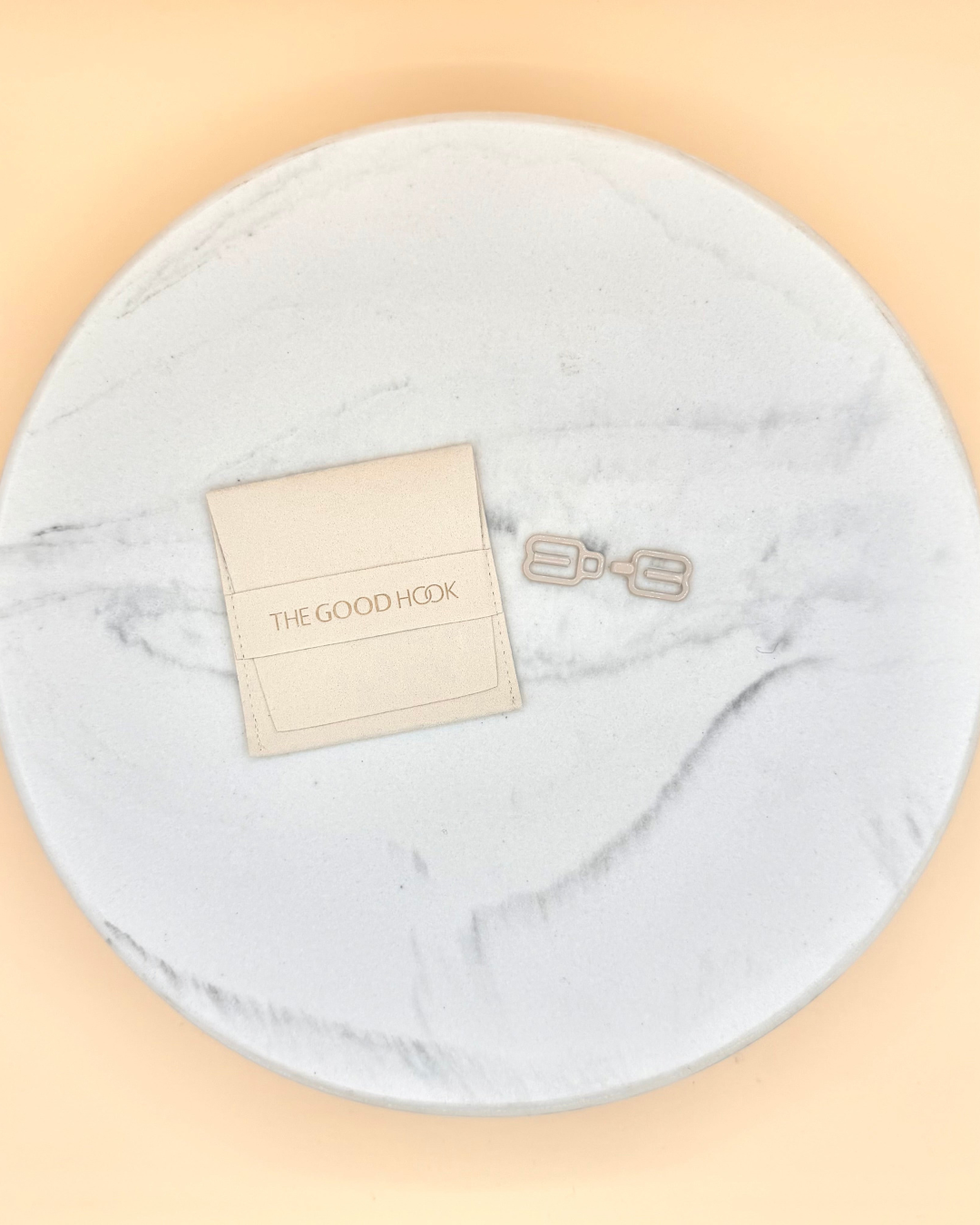 THE GOOD HOOK narrow racerback bra converter clip in beige with storage pouch flat lay.