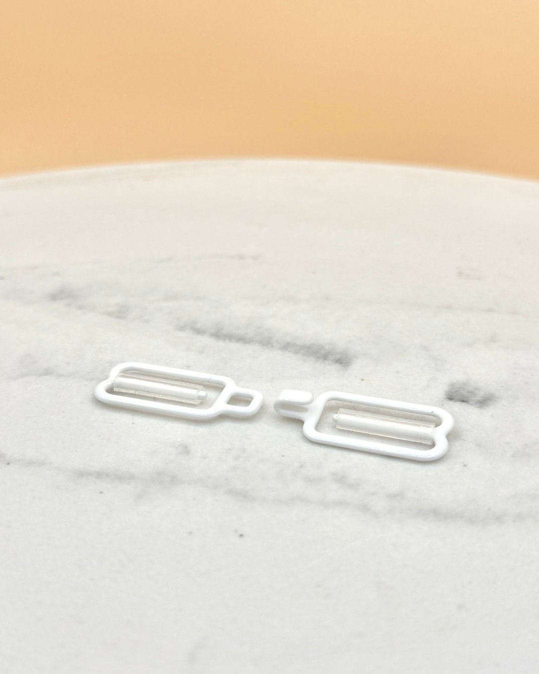 Bra hook clip on a marble surface