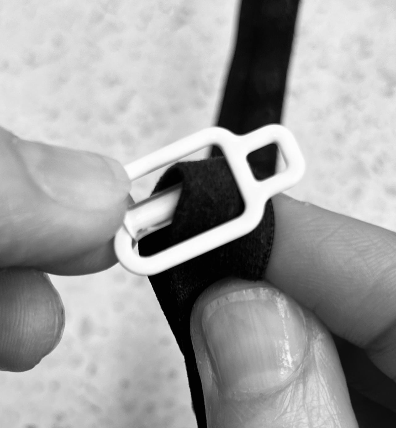 How to attach THE GOOD HOOK bra converter clip onto bra straps - form a loop with bra strap, tilt clip back and slide clip onto bra strap.
